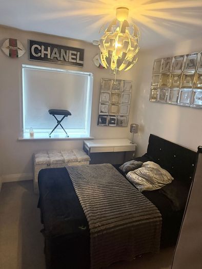 Double bed with headboard and separate storage trunk.