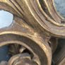 large, ornate gold mirror features a baroque frame Image 7