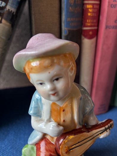 Vintage ceramic figurine of a young Boy Playing a Mandolin