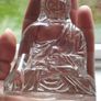 A glass Buddha figurine seated in the lotus position. Image 8