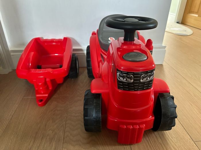 Red ride on tractor with trailer