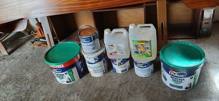 a selection of paint and a paint roller and some good paint brushes