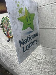 Double sided national lottery wall sign.