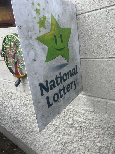 Double sided national lottery wall sign.