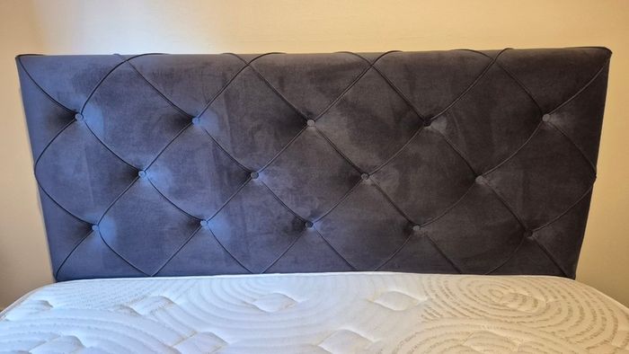 King size ottoman storage bed with navy velvet headboard