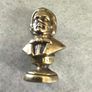 This brass bust appears to be a vintage docertive item / paperweight and pipe tamper or desk accessory depicting the composer Schubert, featuring his name clearly inscribed on the base. Image 2