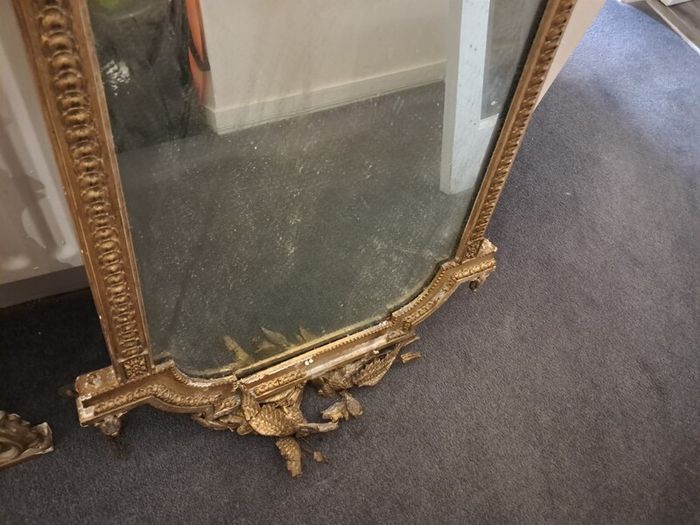 Two distinct antique giltwood mirrors with elaborate French-style ornamentation