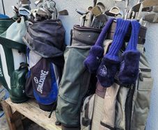 four  golf bags and fifty nine clubs . ONE LOT ONLY.