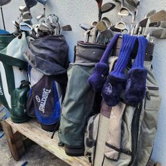four  golf bags and fifty nine clubs . ONE LOT ONLY.