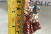 Infant of Prague devotional figurine featuring ornate red and gold robes and a matching crown.