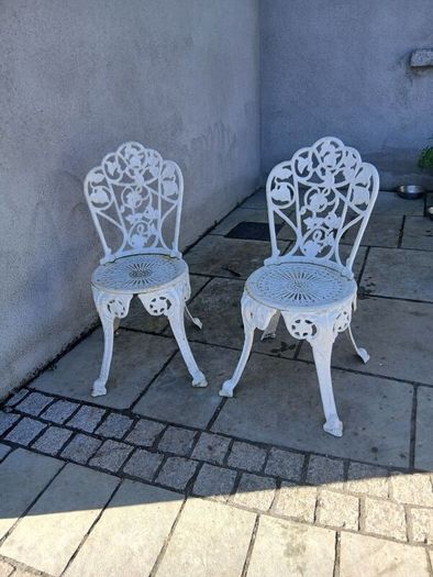 2 cast iron chairs