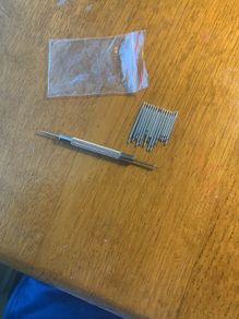Watch bracelet tool and selection of pins.