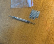 Watch bracelet tool and selection of pins.
