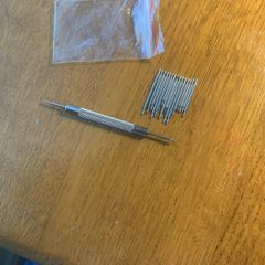 Watch bracelet tool and selection of pins.
