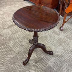19th century mahogany circular occasional table on decorative carved tripod pedestal with paw feet.