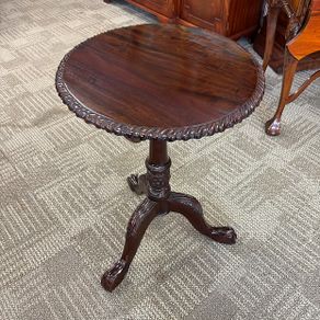 19th century mahogany circular occasional table on decorative carved tripod pedestal with paw feet.