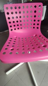 Ikea pink swivel chair with adjustable height.