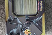 Box of mystery Pokemon in Pikachu and Zekrom tin (Pikachu and Zekrom are not included)