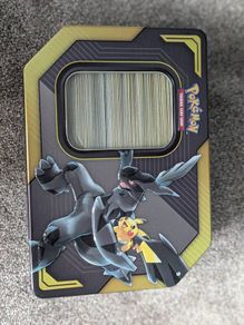 Box of mystery Pokemon in Pikachu and Zekrom tin (Pikachu and Zekrom are not included)
