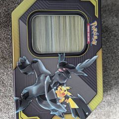 Box of mystery Pokemon in Pikachu and Zekrom tin (Pikachu and Zekrom are not included)