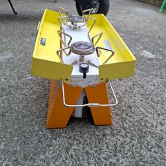 Camping stove with 2 gas bottles.
