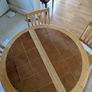 solid pine pedestal dining table with 4 matching four slatted wooden chairs. Image 3