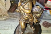Antique French 19th century Bronze Sculpture Auguste Moreau featuring a Winged Putto Cherub Cupid carrying a shell or cornucopia like vessel, mounted on a marble base