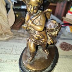 Antique French 19th century Bronze Sculpture Auguste Moreau featuring a Winged Putto Cherub Cupid carrying a shell or cornucopia like vessel, mounted on a marble base