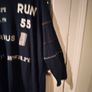 long-sleeved navy garment is an oversized graphic Jacket cardigan. Image 5