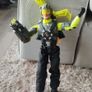 Limited edition This Action Man Air Patrol figure from Hasbro is a 12-inch electronic toy featuring a propeller backpack.The figure wears a distinctive neon yellow and gray flight suit and includes a helmet with a yellow visor. Image 2