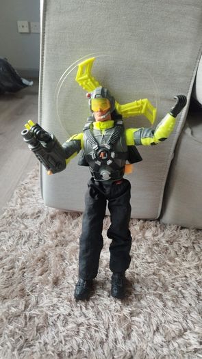 Limited edition This Action Man Air Patrol figure from Hasbro is a 12-inch electronic toy featuring a propeller backpack.The figure wears a distinctive neon yellow and gray flight suit and includes a helmet with a yellow visor.