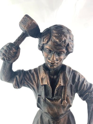 Vintage metal figurine of a blacksmith