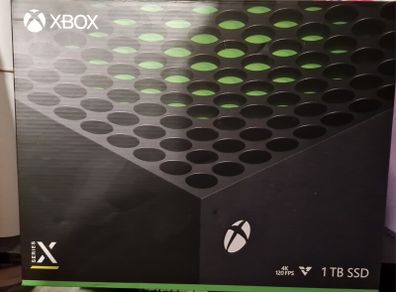 Xbox Series X with box and games