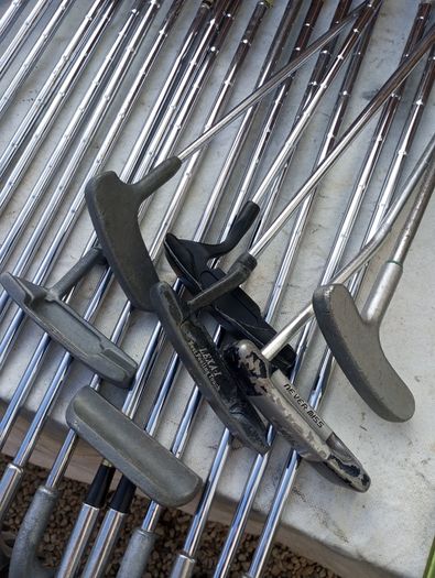 A selection of golf clubs and bags. All right handed clubs.