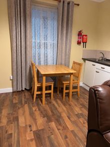 Wooden dining table and two chairs