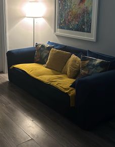 Two navy three seater sofas