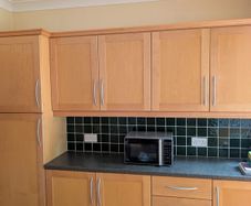 Entire Kitchen including Neff Double Oven, Integrated Fridge-Freezer, Bosch Dishwasher,  Faber Extractor fan, and Microwave.