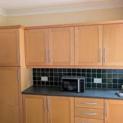Entire Kitchen including Neff Double Oven, Integrated Fridge-Freezer, Bosch Dishwasher,  Faber Extractor fan, and Microwave.