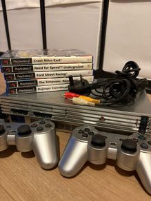 PlayStation 2 with controllers + games