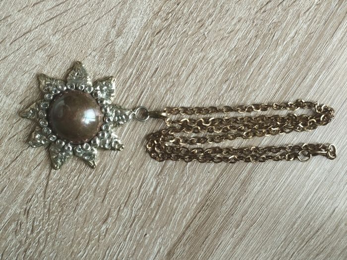 Vintage pendant on a long chain.