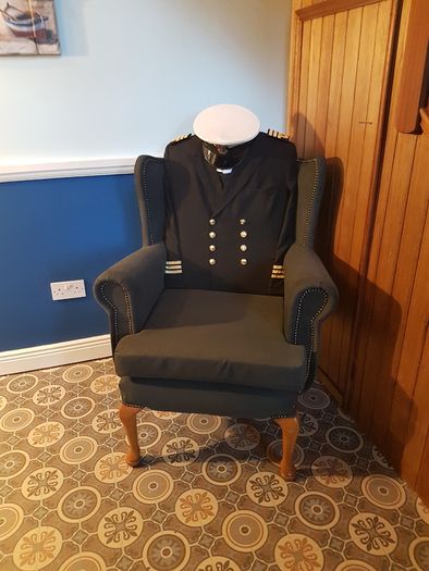 Queen Anne wingback chair / Quirky Ships Commander's uniform.