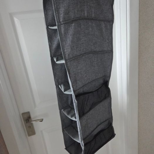 Grey fabric hanging closet organizer with 6 open shelves and side mesh pockets