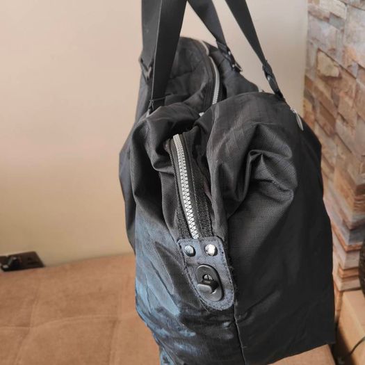 Large black expandable travel bag with shoulder strap