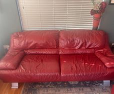 Red leather sofas x 2 plus ottoman