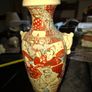Japanese Satsuma vase featuring intricate hand painted designs of figures and patterns.  This type of earthenware pottery often dates to the Meiji period late 19th century or early 20th century Image 2