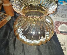 A Beautiful Amber Glass Oil Lamp Shade featuring a bulbous, ribbed body and a wide, ruffled, fluted rim, Postage Available