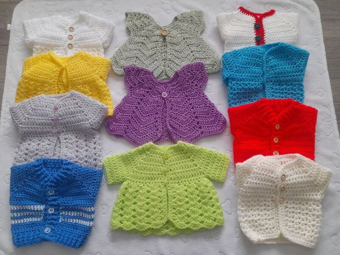 Handmade baby cardigans and dresses from newborn