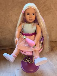 Our Generation doll, hairstyling chair, and accessories