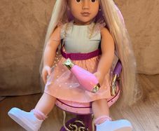 Our Generation doll, hairstyling chair, and accessories