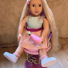 Our Generation doll, hairstyling chair, and accessories